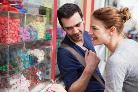 Couple looking at sweets in a window display Stock Photos