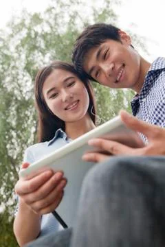 Couple Looking at Tablet Together Stock Photos