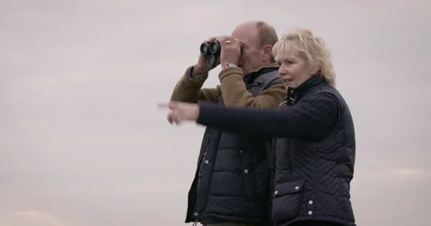 Couple looking through binoculars Stock Footage 59899633
