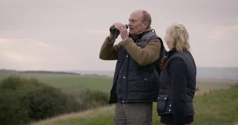 Couple looking through binoculars Stock Footage 59899654