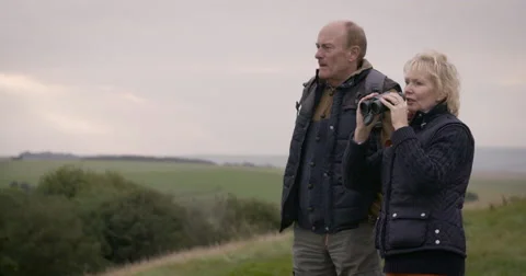 Couple looking through binoculars Stock Footage 59899658