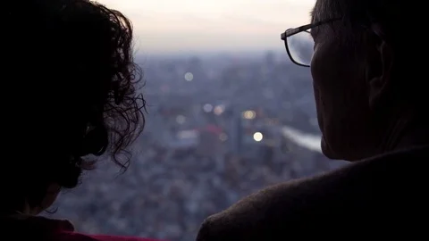 Couple looking at Tokyo cityscape Stock Footage