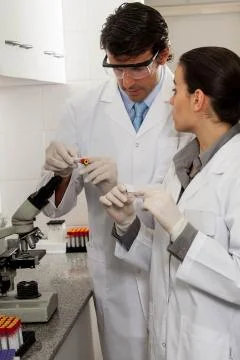 Couple looking at the tubes in the lab Stock-Fotos