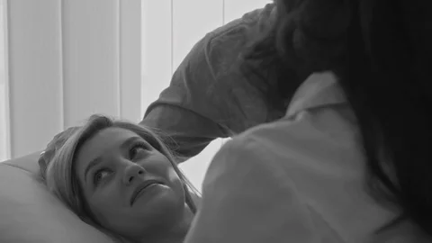Couple looking at ultrasound scan of baby on tablet pc on sofa Stock Footage