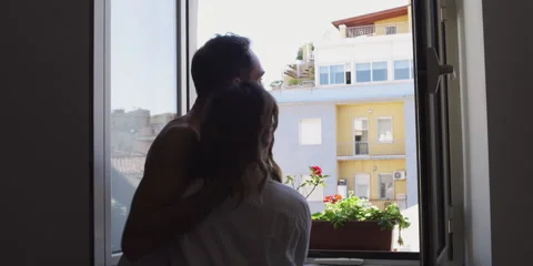 Couple looking at view from window Video stock 58860329