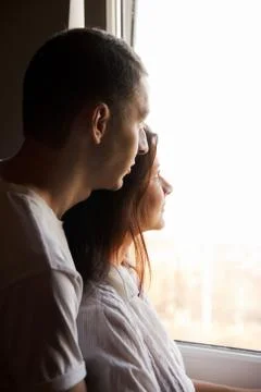 Couple looking to the window Stock Photos
