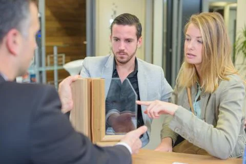 Couple looking at window samples Stock Photos