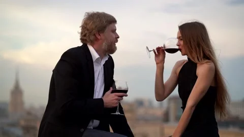 A couple in love: a bearded man in a jacket and shirt and a young slender girl Stock Footage 134736088
