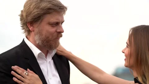 A couple in love: a bearded man in a jacket and shirt and a young slender long Stock Footage 134842819