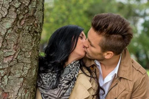 Couple in love behind a tree Stock Photos