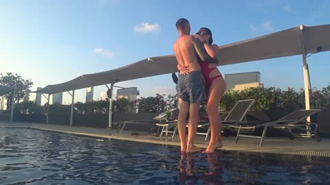 A couple in love falls into the pool Stock Footage 130191269