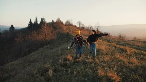 Couple in love hiking outdoors. Hikers man and woman trekking running with Stock Footage