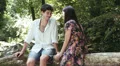 a couple in love holding hand and kissing - near river HD Footage