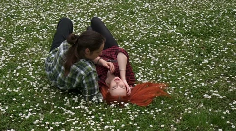 A couple in love lying in spring grass and flowers Video stock 62882675