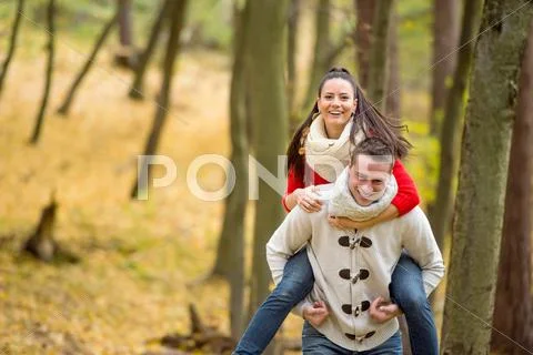 Couple in love, man giving his woman piggyback Stock Photos