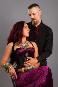 Couple in love posing at studio dressed in classic clothe Stock Photos