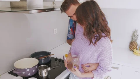 Couple in love preparing cup of coffee in the kitchen Stock Footage 99397826