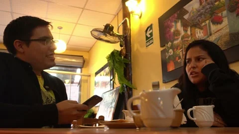 A couple in love in a restaurant arguing while waiting for their food Stock Footage 196729921