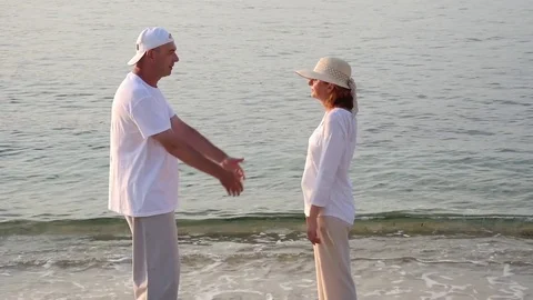 Couple in love on the sandy beach in the sunset Stock Footage 78075151