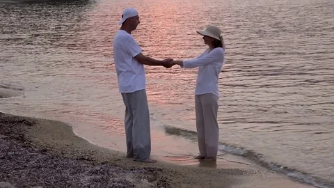 Couple in love on the sandy beach in the sunset Stock Footage 78075280