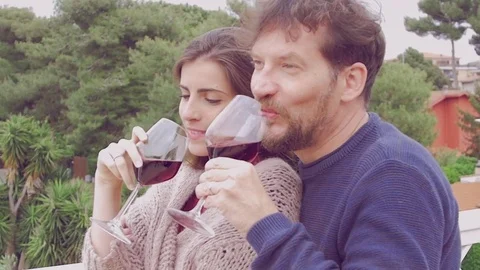 Couple in love smiling having fun in restaurant toasting with red wine slow.. Stock Footage 75530004