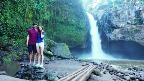 Couple in love under a waterfall in the ... | Stock Video | Pond5