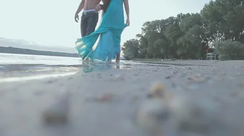 Couple in love walking on the shallow Stock Footage 10860095