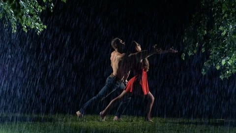 Couple of lovers dance under the rain. Stock Footage 247922881