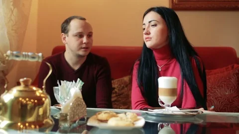 Couple of lovers, having fun drinking tea and coffee in a cafe Stock Footage 77732120