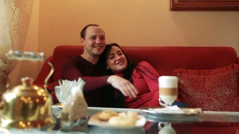 Couple of lovers, having fun drinking tea and coffee in a cafe Stock Footage 77733078