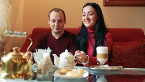 Couple of lovers, having fun drinking tea and coffee in a cafe Stock Footage 77733909