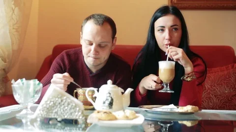 Couple of lovers, having fun drinking tea and coffee in a cafe Stock Footage 77734101