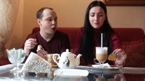 Couple of lovers, having fun drinking tea and coffee in a cafe Stock Footage 84218493