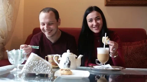 Couple of lovers, having fun drinking tea and coffee in a cafe Stock Footage 84220029