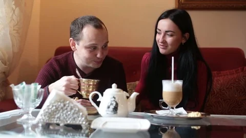 Couple of lovers, having fun drinking tea and coffee in a cafe Stock Footage 84220431