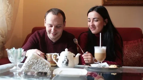 Couple of lovers, having fun drinking tea and coffee in a cafe Stock Footage 84220875