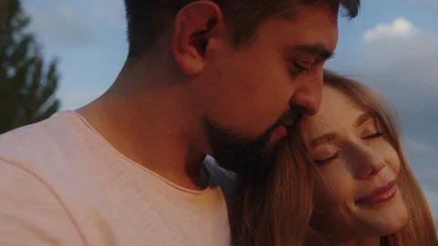 Couple lovers hugging affectionate in the park at sunset. Love, youth, happiness Video stock 250309606