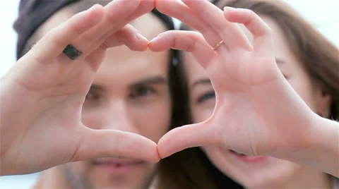 Couple of lovers looking at the camera and show heart 動画素材 40605545