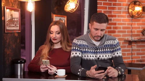 Couple of lovers at a restaurant drinking coffee and making selfie Stock Footage 87096696
