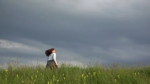 Couple of lovers running on spring hill, man caching woman, dramatic sky  Stock Footage 46206623