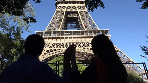 Couple of lovers silhouette caressing their hands, man and woman admiring Eiffel Stock Footage 69181247
