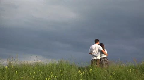 Couple of lovers standing on spring top hill close to sky, admire nature 4K Stock Footage 46205981