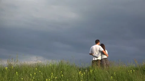 Couple of lovers standing on spring top hill close to sky, admire nature  Video stock 46206672