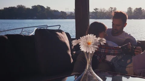 Couple lying and drinking coffee by the river 스톡 동영상 99981964