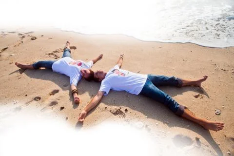 Couple lying on the beach Foto stock