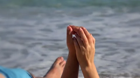 Couple lying on beach sand , hands playing, sea waving 4K Stock Footage 42997949