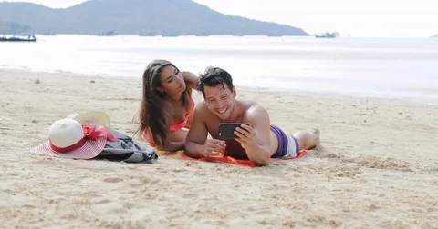 Couple Lying On Beach Taking Selfie Photo On Cell Smart Phone Talking, Young Man Stock Footage 75819576