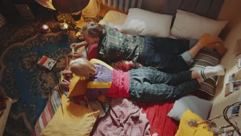 Couple Lying on Bed and Playing Retro Console Game Vídeo Stock 154985955