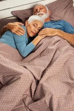 Couple lying in bed sleeping Stock Photos