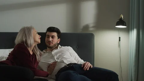 Couple lying in bed together Stock Footage 99941511